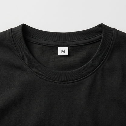 Close-up front neckline of the black T-shirt with an M size label