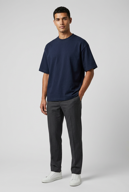 Stylish studio model pose wearing the dark navy oversized T-shirt against a gray background